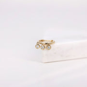 Picture of huggie hoop earrings with three diamond