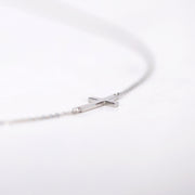 Picture of gold sideways cross necklace cross