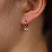 Picture of huggie hoop earrings with three diamond